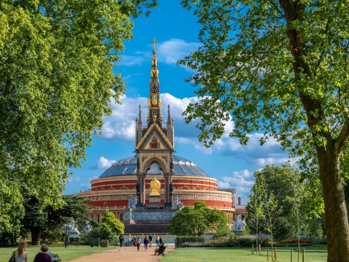 The Albert memorial statue monument against the Royal Hall in Hyde park of London