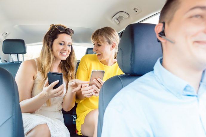 Two women in chauffeur driven car