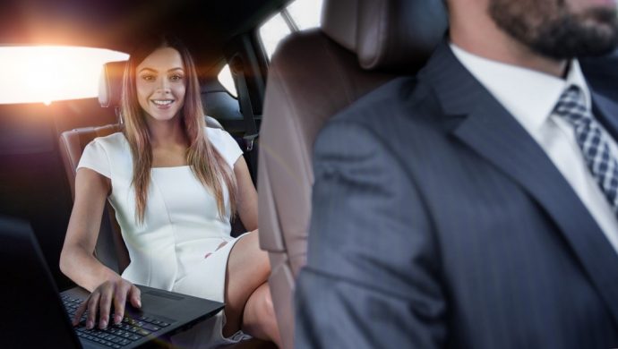 Business women in chauffeur driven car